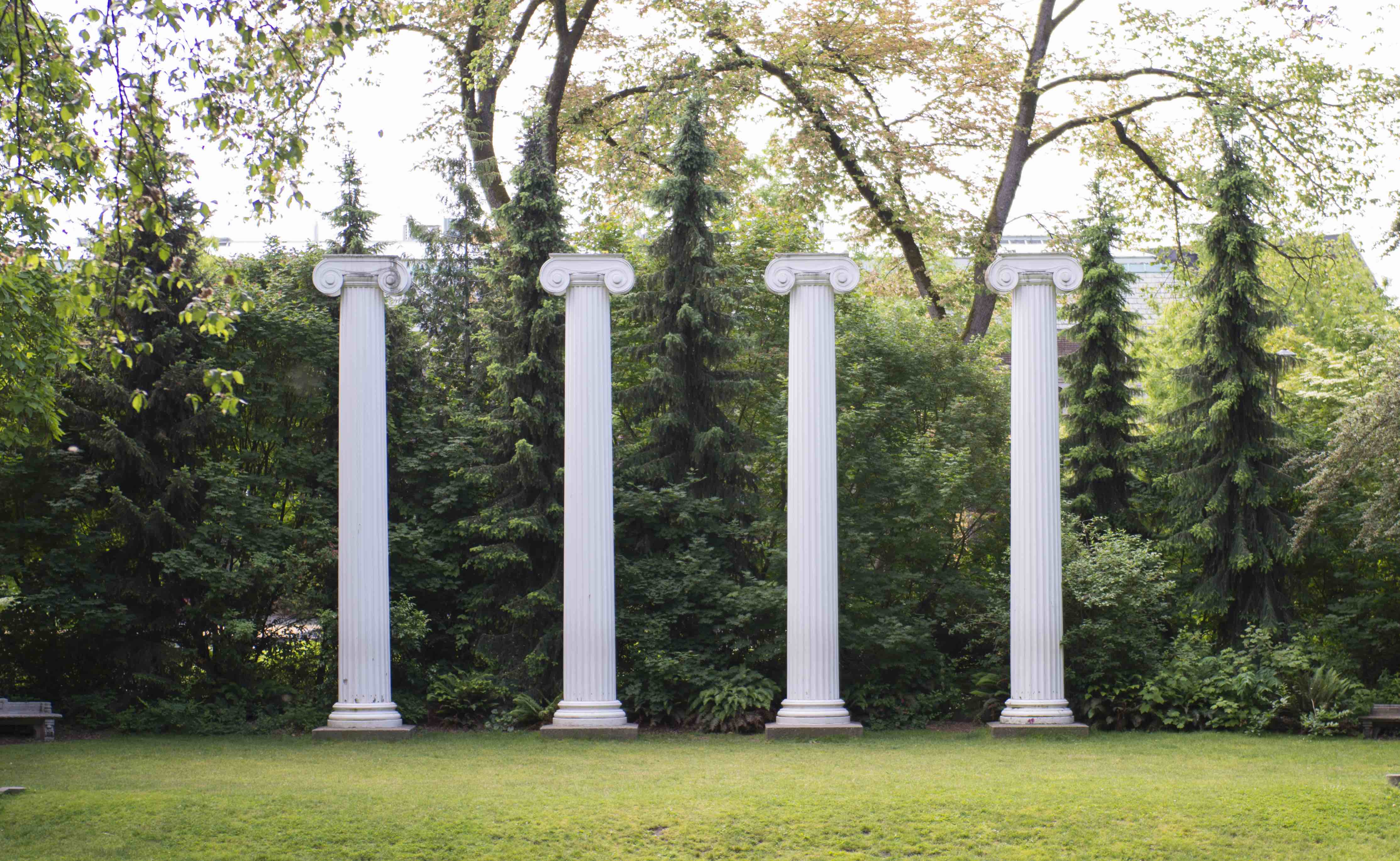 Architectural columns in a grove of trees