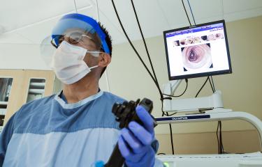 A doctor holds a camera ready to conduct a colonoscopy